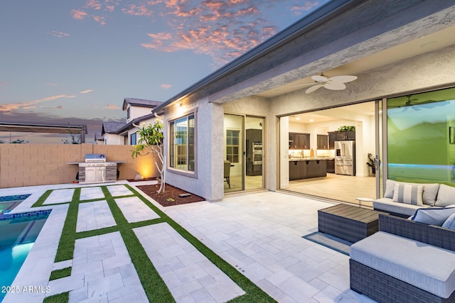 2316 E Canary Dr, Gilbert, AZ 85297 - fenced backyard featuring a ceiling fan, a patio, outdoor lounge area, and exterior kitchen