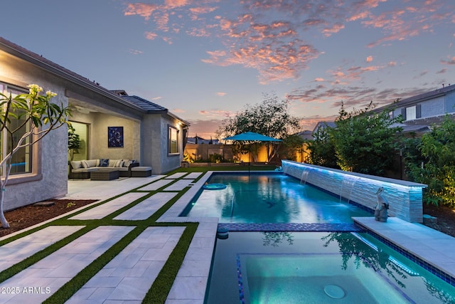 2316 E Canary Dr, Gilbert, AZ 85297 - pool at dusk featuring outdoor lounge area, a patio, a fenced backyard, and a pool with connected hot tub