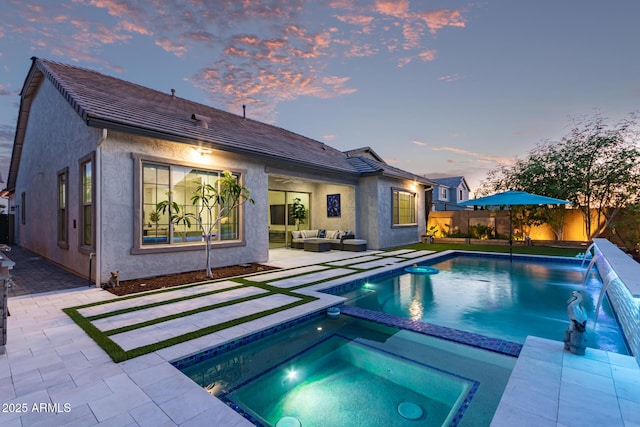 2316 E Canary Dr, Gilbert, AZ 85297 - back of property with outdoor lounge area, a patio, a fenced backyard, stucco siding, and a pool with connected hot tub