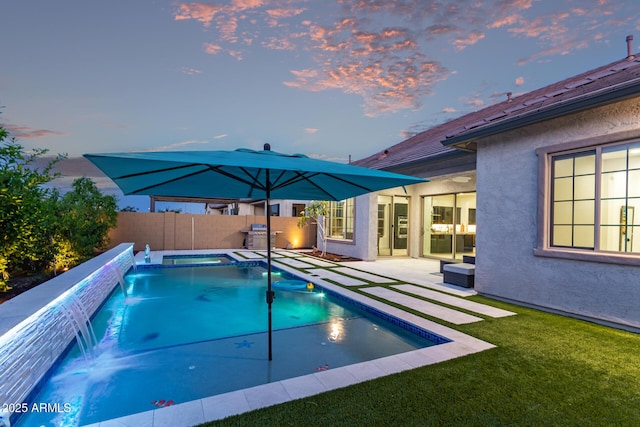 2316 E Canary Dr, Gilbert, AZ 85297 - pool at dusk with a patio, a pool with connected hot tub, and a grill