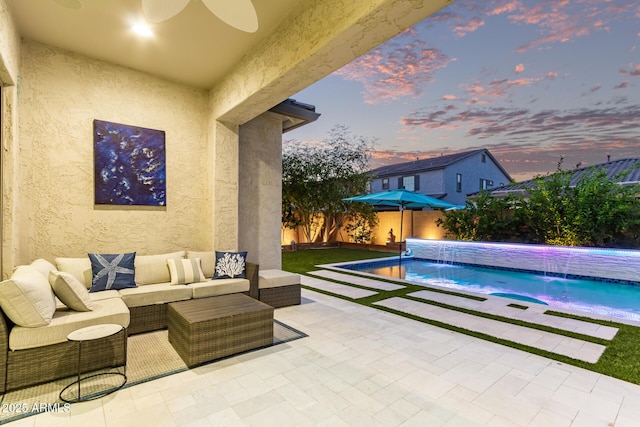 2316 E Canary Dr, Gilbert, AZ 85297 - pool at dusk featuring a patio area, an outdoor hangout area, a fenced backyard, and a pool with connected hot tub
