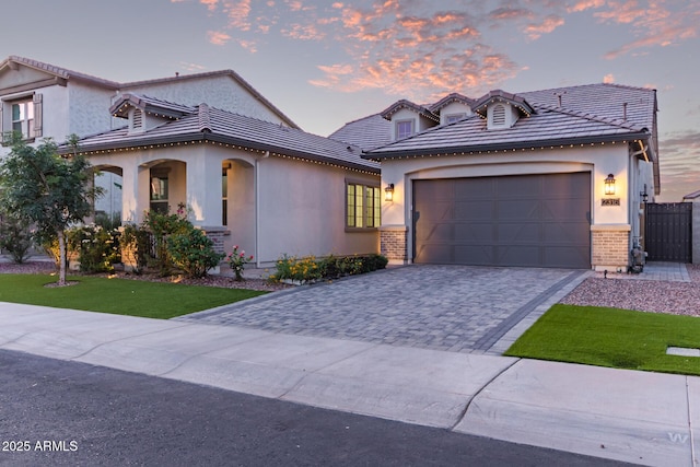 2316 E Canary Dr, Gilbert, AZ 85297 - view of front of home featuring stucco siding, decorative driveway, a garage, a lawn, and a porch