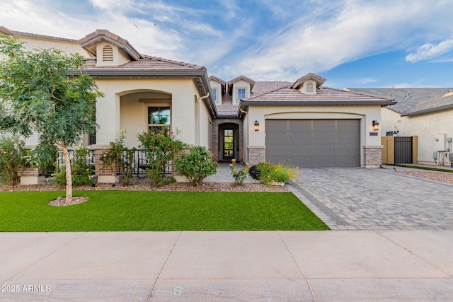 2316 E Canary Dr, Gilbert, AZ 85297 - view of front of home with stucco siding, decorative driveway, a front yard, and a garage