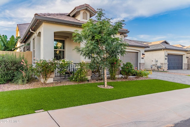 2316 E Canary Dr, Gilbert, AZ 85297 - view of front of house featuring stucco siding, a front yard, a garage, driveway, and a tile roof