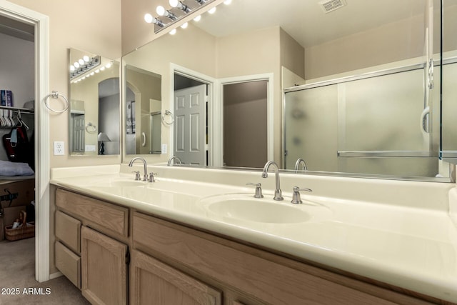 bathroom with vanity and an enclosed shower