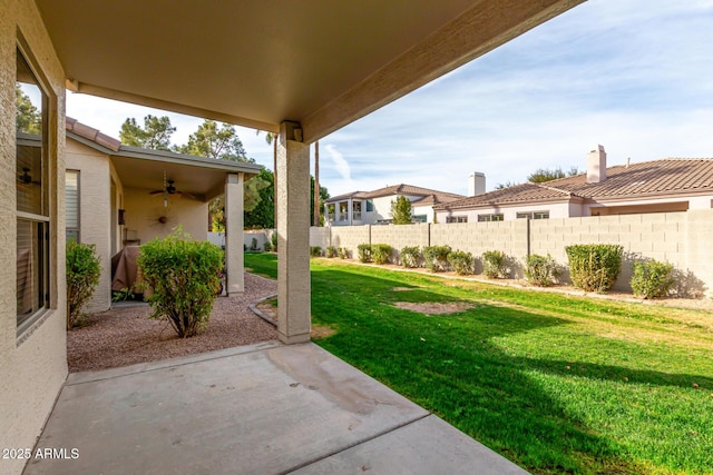 view of yard with ceiling fan and a patio area