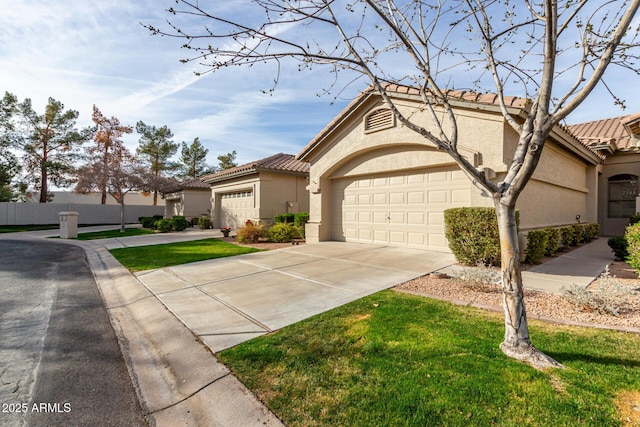 view of front of property featuring a garage and a front lawn