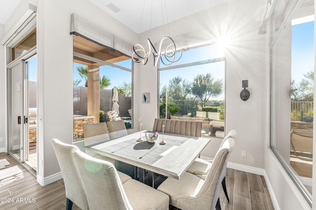 dining room featuring plenty of natural light and a notable chandelier