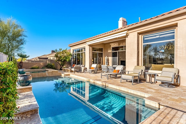 view of pool with an in ground hot tub and a patio