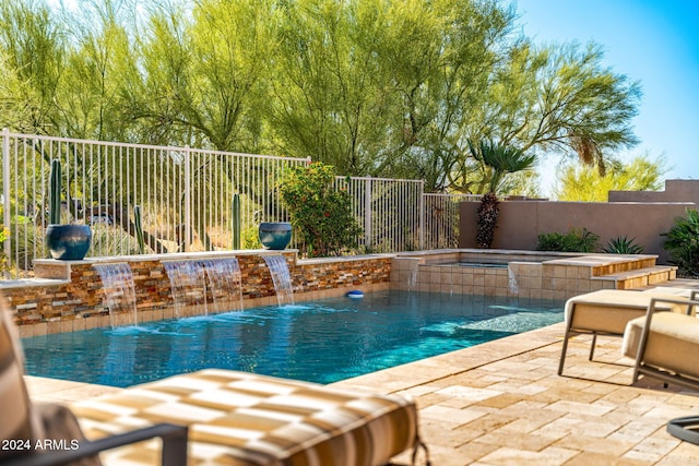 view of swimming pool featuring pool water feature, an in ground hot tub, and a patio