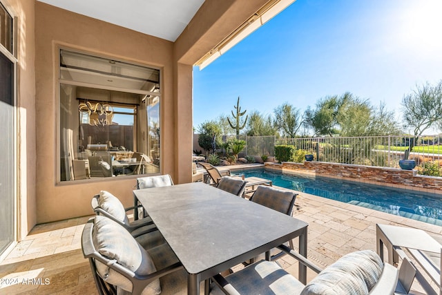 view of patio with a fenced in pool