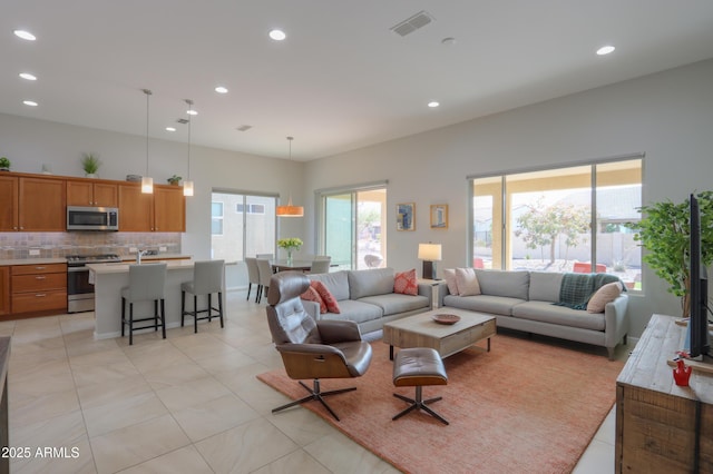 living room with a healthy amount of sunlight and light tile patterned flooring