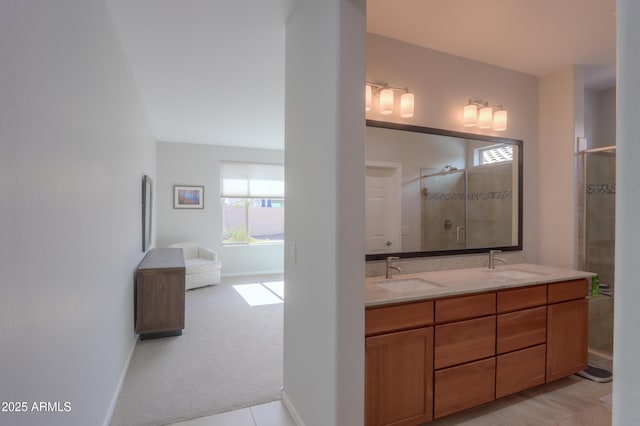 bathroom with a shower with shower door and vanity