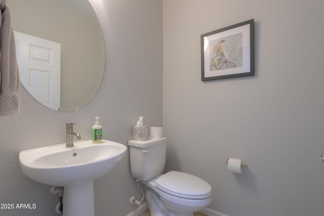 bathroom featuring toilet and sink