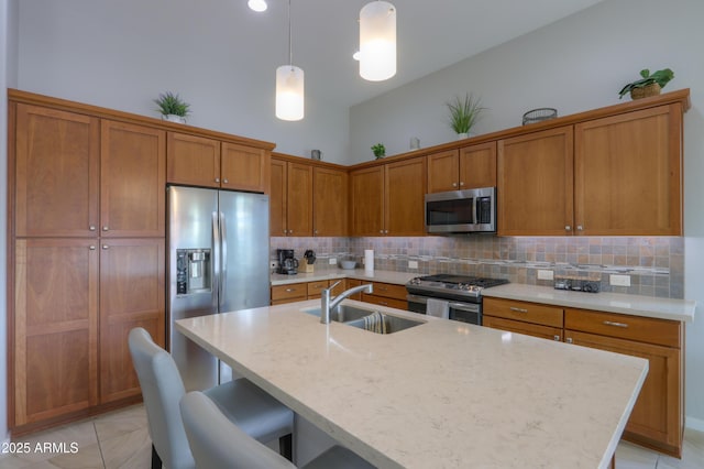 kitchen featuring a breakfast bar area, sink, tasteful backsplash, and stainless steel appliances