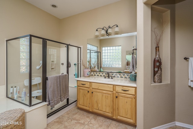 bathroom with walk in shower, vanity, and tile patterned floors