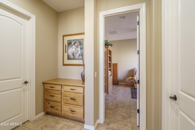 hall featuring light tile patterned floors