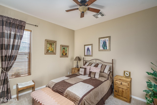 bedroom featuring light carpet and ceiling fan