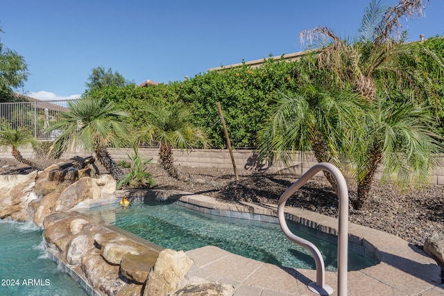 view of pool featuring a jacuzzi and pool water feature