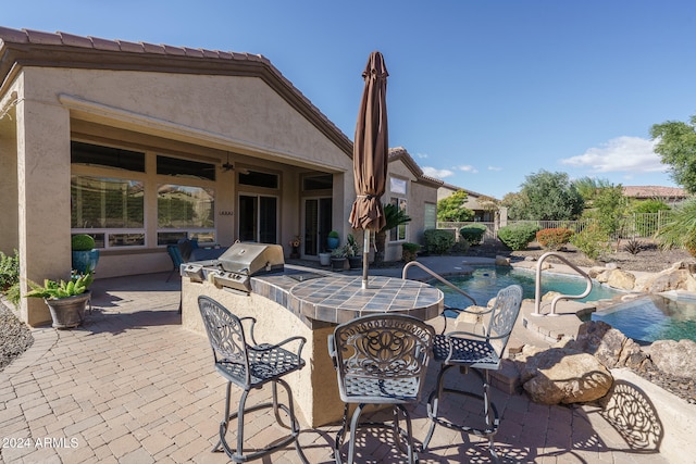 view of patio featuring area for grilling and a fenced in pool