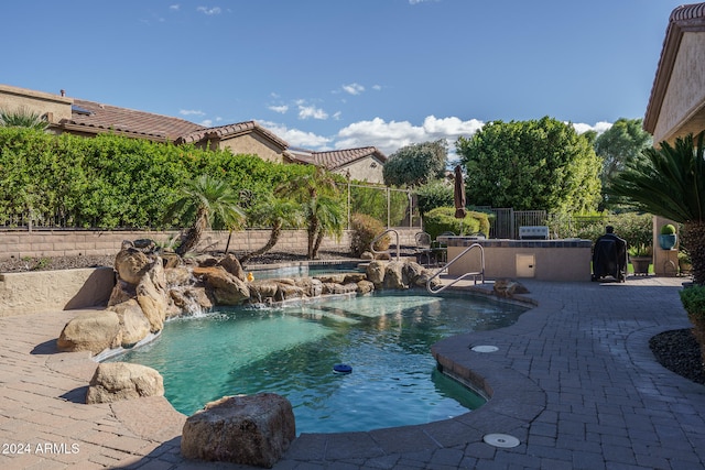 view of pool featuring a patio area and pool water feature