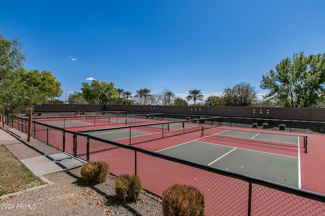 view of tennis court with basketball hoop