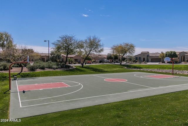 view of basketball court with a lawn