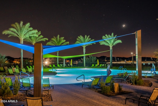 pool at night with a patio