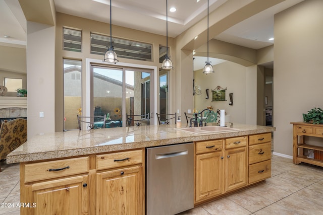 kitchen featuring sink, light brown cabinetry, light tile patterned floors, pendant lighting, and dishwasher