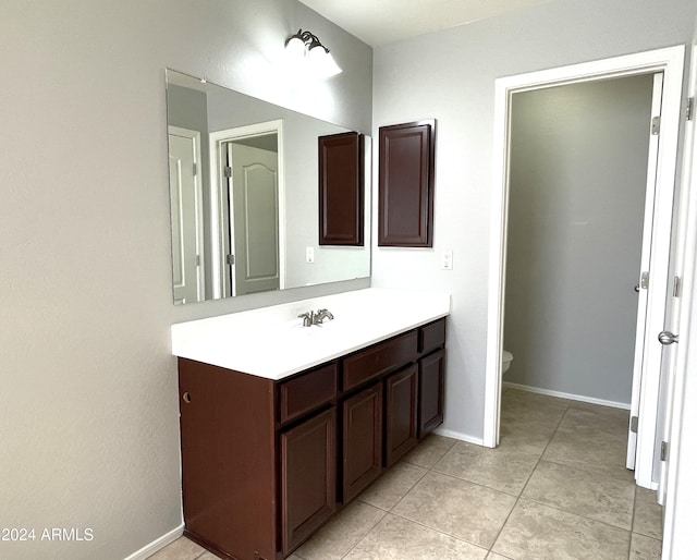 bathroom featuring toilet, vanity, and tile patterned floors