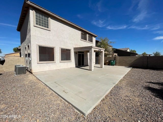 rear view of property featuring a patio area and cooling unit