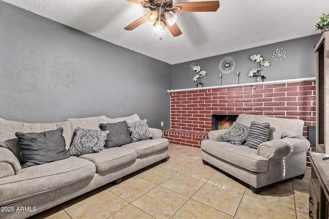 6408 W College Dr, Phoenix, AZ 85033 - tiled living room featuring ceiling fan, a brick fireplace, and a textured ceiling