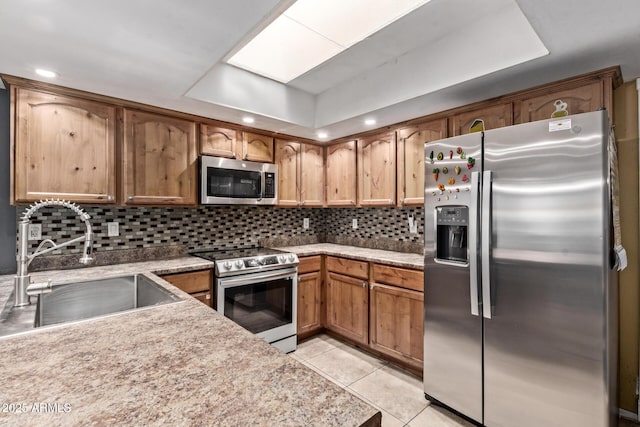 6408 W College Dr, Phoenix, AZ 85033 - kitchen with light tile patterned flooring, appliances with stainless steel finishes, sink, and decorative backsplash
