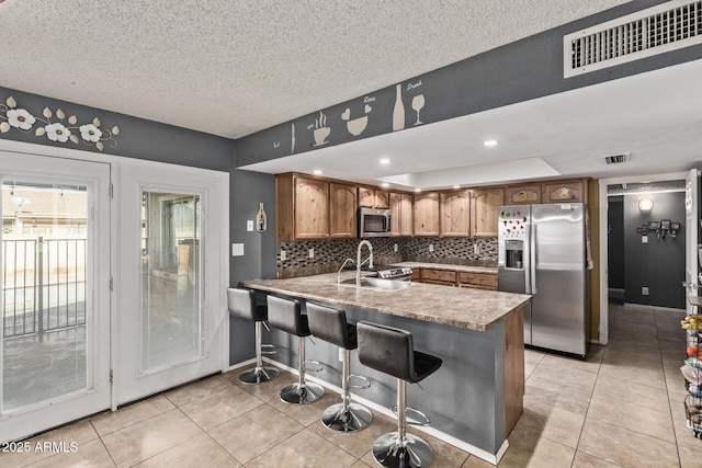 6408 W College Dr, Phoenix, AZ 85033 - kitchen with stainless steel appliances, light tile patterned flooring, and kitchen peninsula