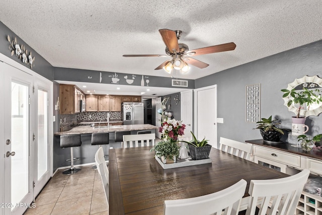 6408 W College Dr, Phoenix, AZ 85033 - tiled dining room with sink, a textured ceiling, and ceiling fan