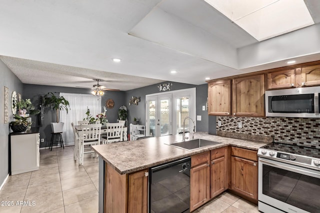 6408 W College Dr, Phoenix, AZ 85033 - kitchen featuring french doors, sink, kitchen peninsula, stainless steel appliances, and decorative backsplash