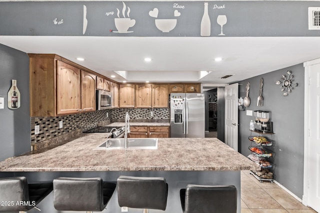 6408 W College Dr, Phoenix, AZ 85033 - kitchen featuring light tile patterned flooring, sink, tasteful backsplash, kitchen peninsula, and stainless steel appliances