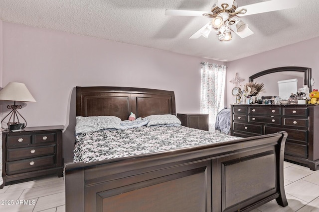 6408 W College Dr, Phoenix, AZ 85033 - bedroom featuring ceiling fan, a textured ceiling, and light tile patterned floors