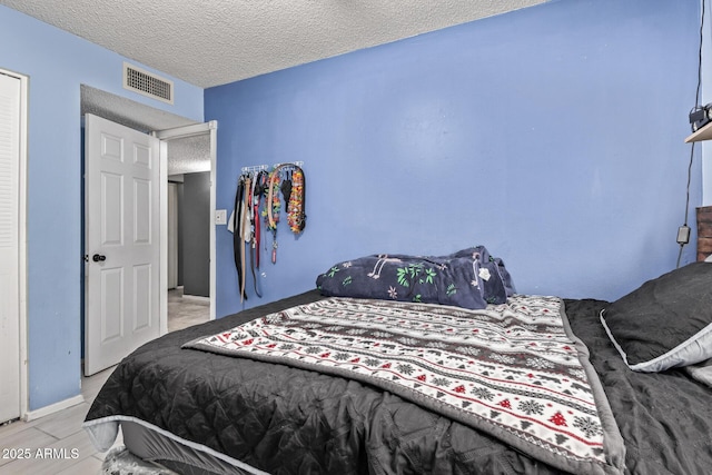 6408 W College Dr, Phoenix, AZ 85033 - bedroom with a textured ceiling and light wood-type flooring