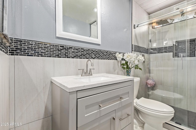 6408 W College Dr, Phoenix, AZ 85033 - bathroom featuring vanity, a shower with door, toilet, and tile walls