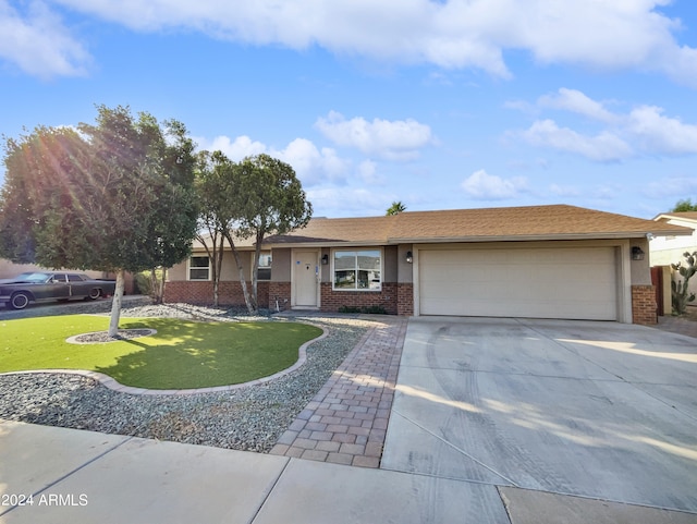 single story home with a front yard and a garage