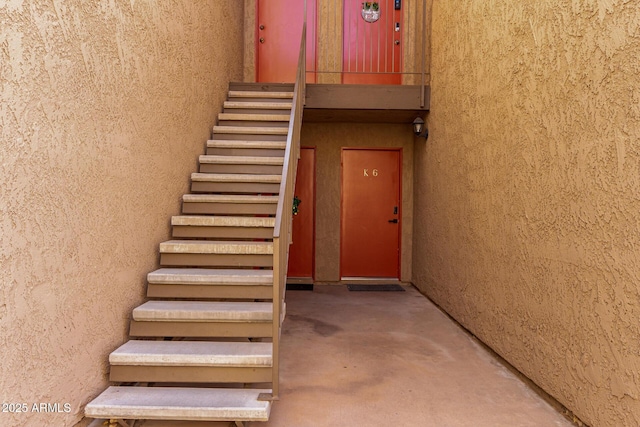 stairway featuring concrete floors