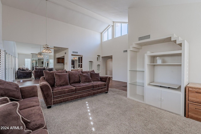 living room with beam ceiling, high vaulted ceiling, ceiling fan, and hardwood / wood-style floors