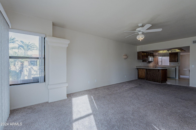 unfurnished living room with ceiling fan and light colored carpet