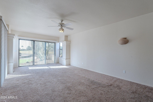 unfurnished room with carpet flooring, a textured ceiling, and ceiling fan