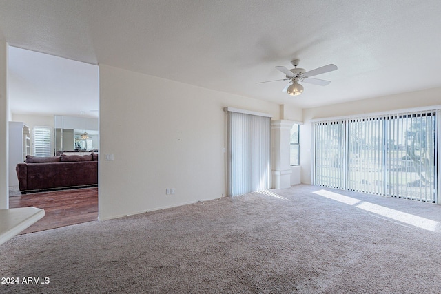 spare room featuring ceiling fan, carpet floors, a textured ceiling, and a wealth of natural light