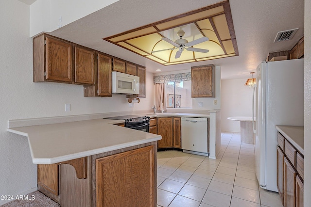 kitchen featuring white appliances, ceiling fan, a textured ceiling, light tile patterned flooring, and kitchen peninsula