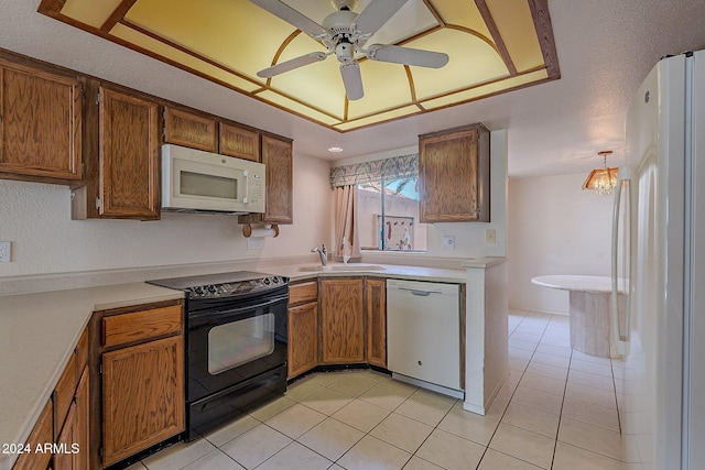 kitchen featuring white appliances, ceiling fan with notable chandelier, sink, hanging light fixtures, and light tile patterned flooring