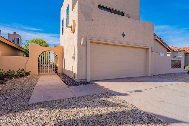 view of home's exterior featuring a garage and central AC unit