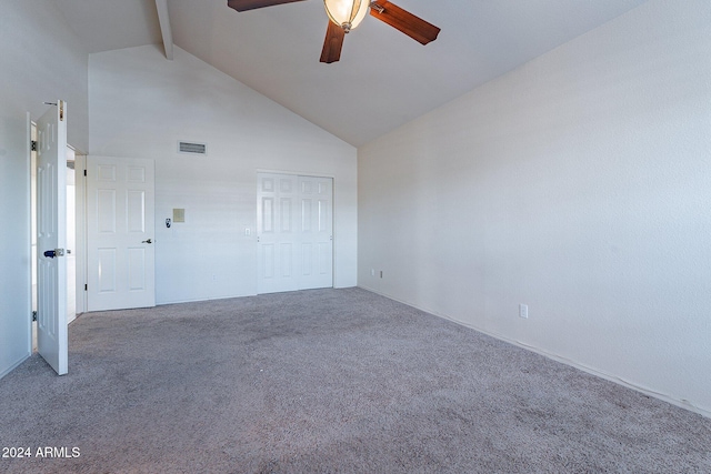 empty room featuring carpet flooring, beam ceiling, high vaulted ceiling, and ceiling fan